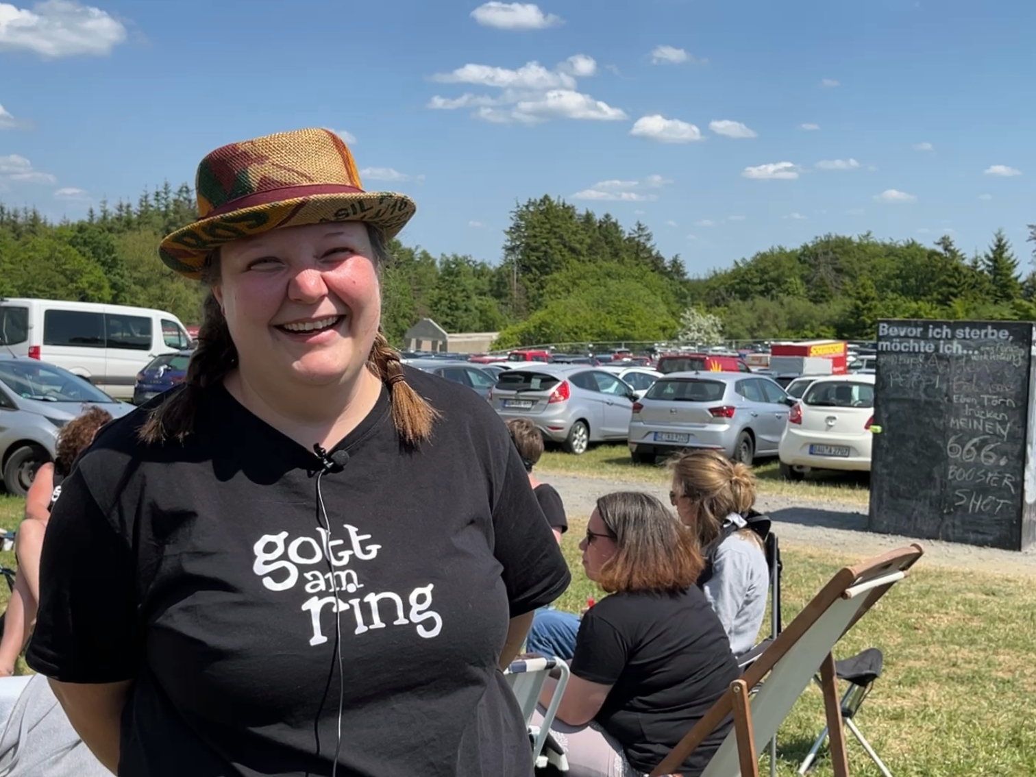 Eine Frau mit Hut und TShirt mit der Aufschrift 'Gott am Ring'